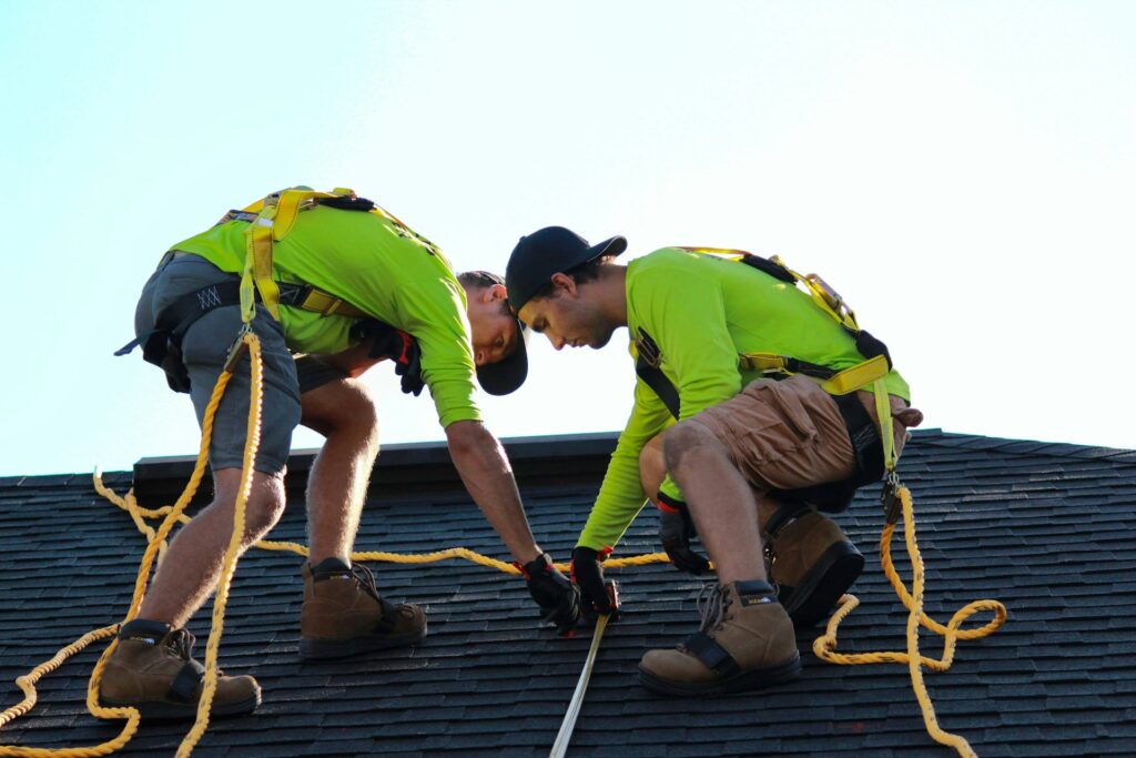 Homeowner in Vancouver, WA, reviewing a roofing contract with a professional in front of a suburban home