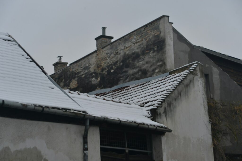 Storm damaged roof inspection in Pacific Northwest showing HOMEMASTERS professional assessment after severe weather