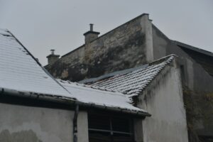 Storm damaged roof inspection in Pacific Northwest showing HOMEMASTERS professional assessment after severe weather