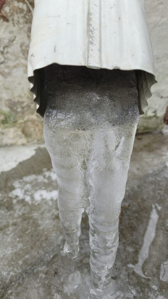 Roofing crew installing new asphalt shingles on Medford Oregon home during mild December weather