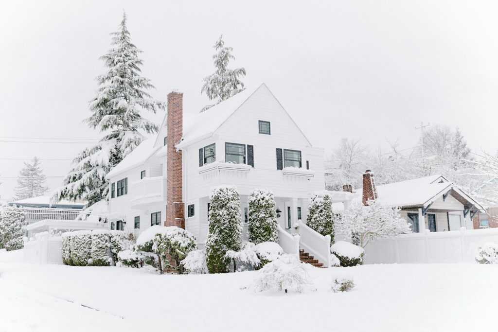 Heavy snow accumulation on a Central Oregon home roof near Bend with Mt Bachelor visible in the background