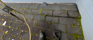 Thick moss growth on north-facing shingles on a Portland East Oregon home roof