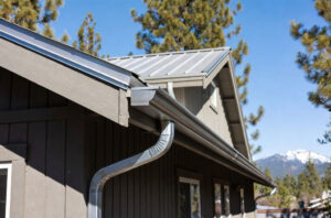 HOMEMASTERS crew installing six-inch seamless aluminum gutters on a Bend Oregon home in May