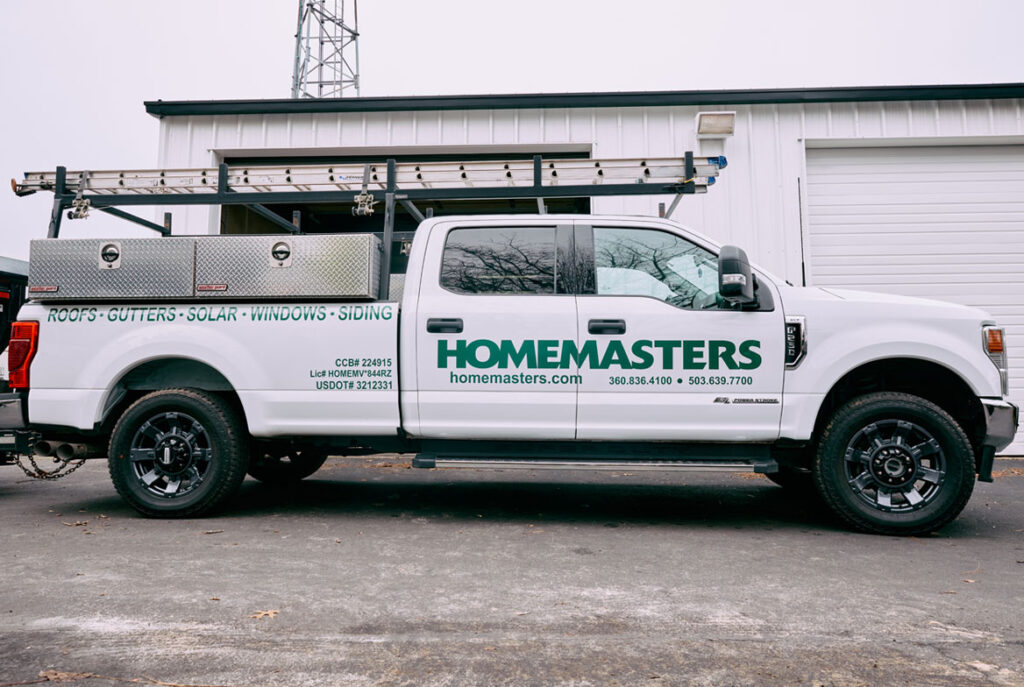 HOMEMASTERS Vancouver crew inspecting a commercial TPO flat roof on a Clark County Washington building in summer