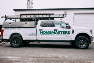 HOMEMASTERS Vancouver crew inspecting a commercial TPO flat roof on a Clark County Washington building in summer