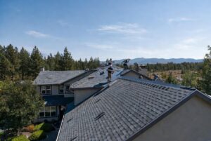 HOMEMASTERS Bend roofing crew installing new shingles on a Central Oregon home in peak summer July