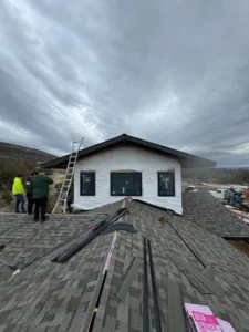 HOMEMASTERS Bend certified roofing contractor reviewing an itemized estimate with a Central Oregon homeowner