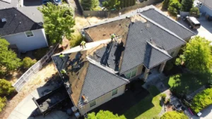 HOMEMASTERS Southern Oregon crew mid tear-off on a Medford Oregon roof replacement with property protection in place