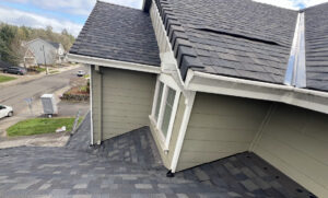 Seamless aluminium gutter and downspout on a Tualatin, OR home with a shingle roof under mature trees
