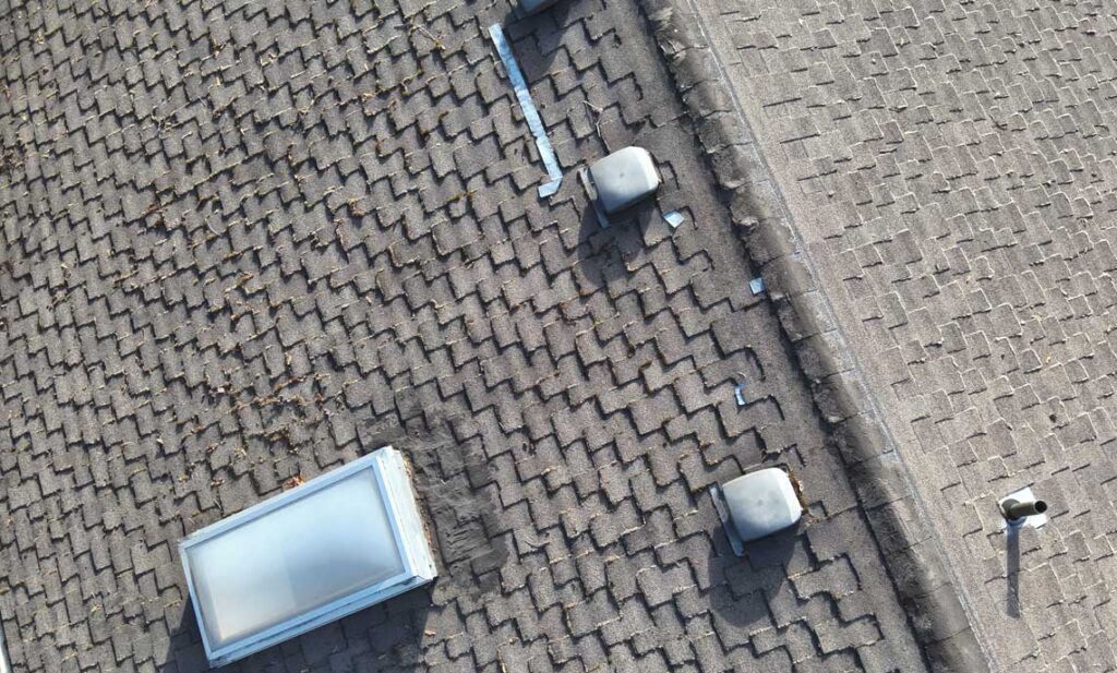 Ridge vent and soffit intake on a reroofed shingle home, roof ventilation by