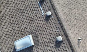 Ridge vent and soffit intake on a reroofed shingle home, roof ventilation by