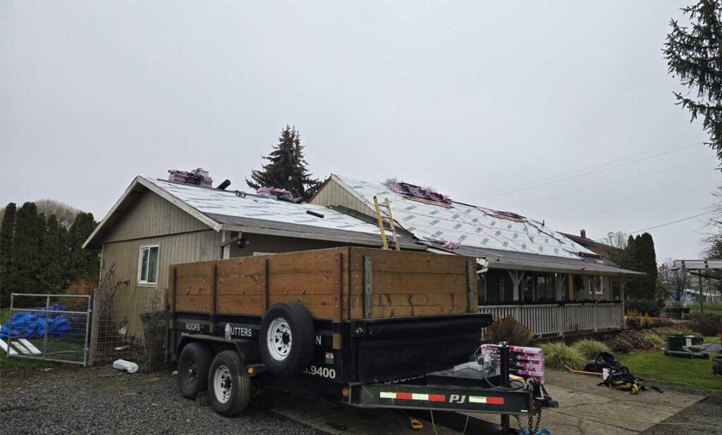 Roof dried in with synthetic underlayment and shingles staged on an overcast day, fall roof replacement for Keizer