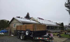 Roof dried in with synthetic underlayment and shingles staged on an overcast day, fall roof replacement for Keizer