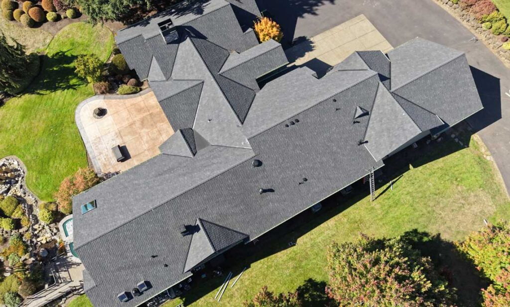 Roofer checking asphalt shingle condition and granule loss to estimate remaining roof life, HOMEMASTERS