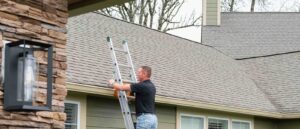 Roofer inspecting asphalt shingles and flashing on a home, roof inspection by HOMEMASTERS Vancouver for Hazel Dell