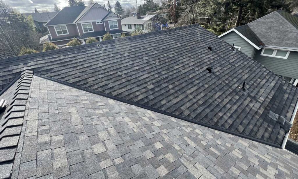 New architectural shingle roof with continuous ridge vent and sealed pipe boots, winter roof prep for Sunriver homes